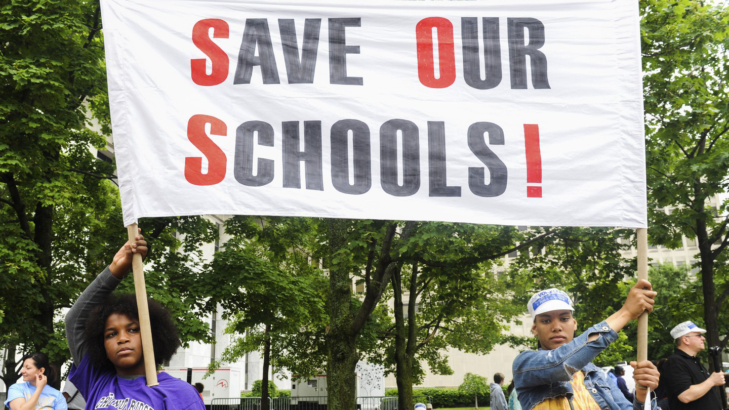 "Image 1. Decelle (2017) "Students of the East Ramapo School District hold a sign during the One Voice United Rally in Albany". Retrieved July 7, 2020 from The Atlantic website: https:/www.theatlantic.com/education/archive/2017/11/another-blow-to-one-of-americas-most-controversial-school-board/546227/."